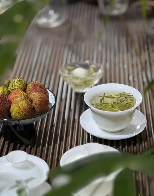 Porcelain teacup filled with light green tea, symbolizing freshness and clarity