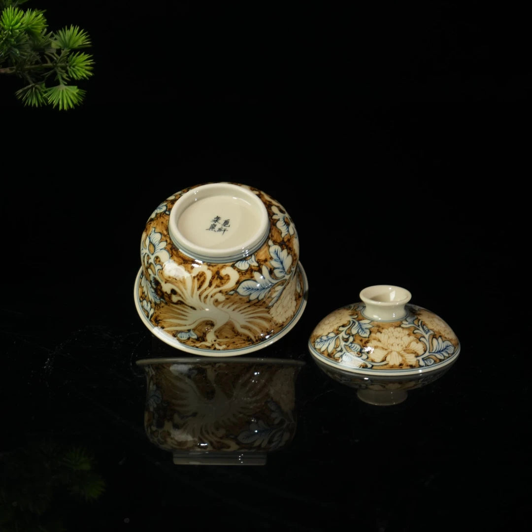 Hand-painted phoenix design on gaiwan with underglaze blue and gold detailing
