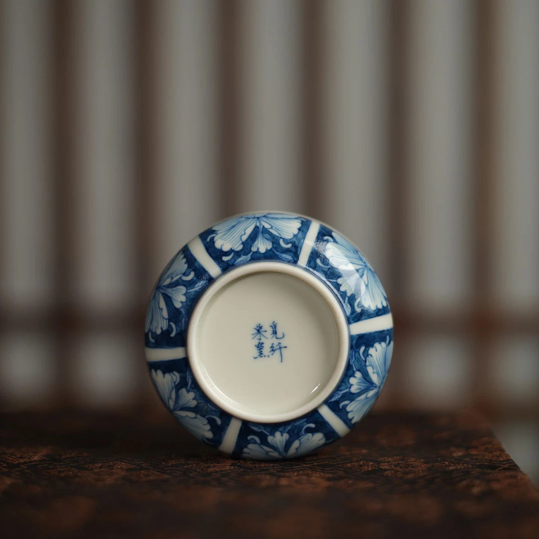 Traditional Qinghua porcelain teacup with a hidden floral surprise at the bottom.