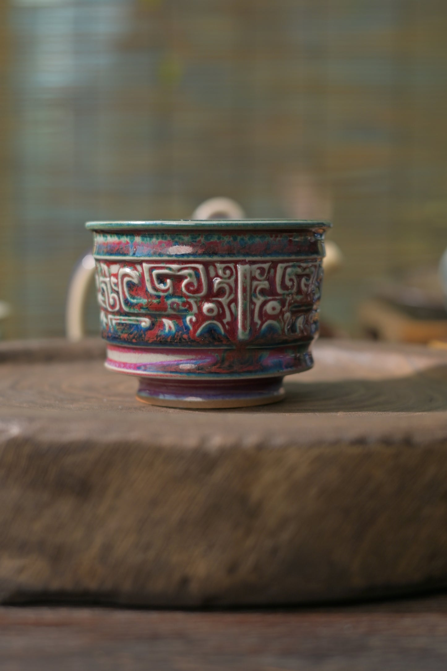 High-fired handmade teacup with dramatic flambé glaze interior effect