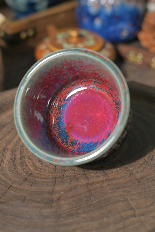 Unique Jun ware teacup with red and blue kiln-transformed glaze details