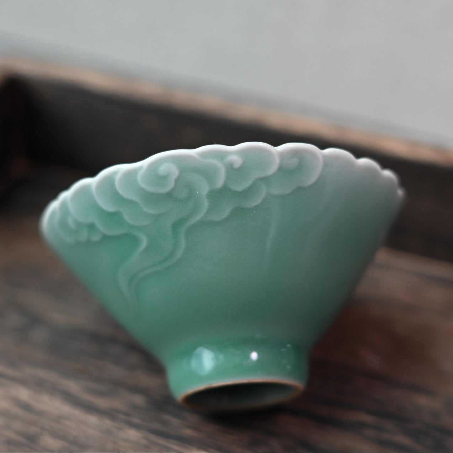 Auspicious cloud tea ware handcrafted in Longquan, featuring raised patterns that enhance grip and aesthetic appeal