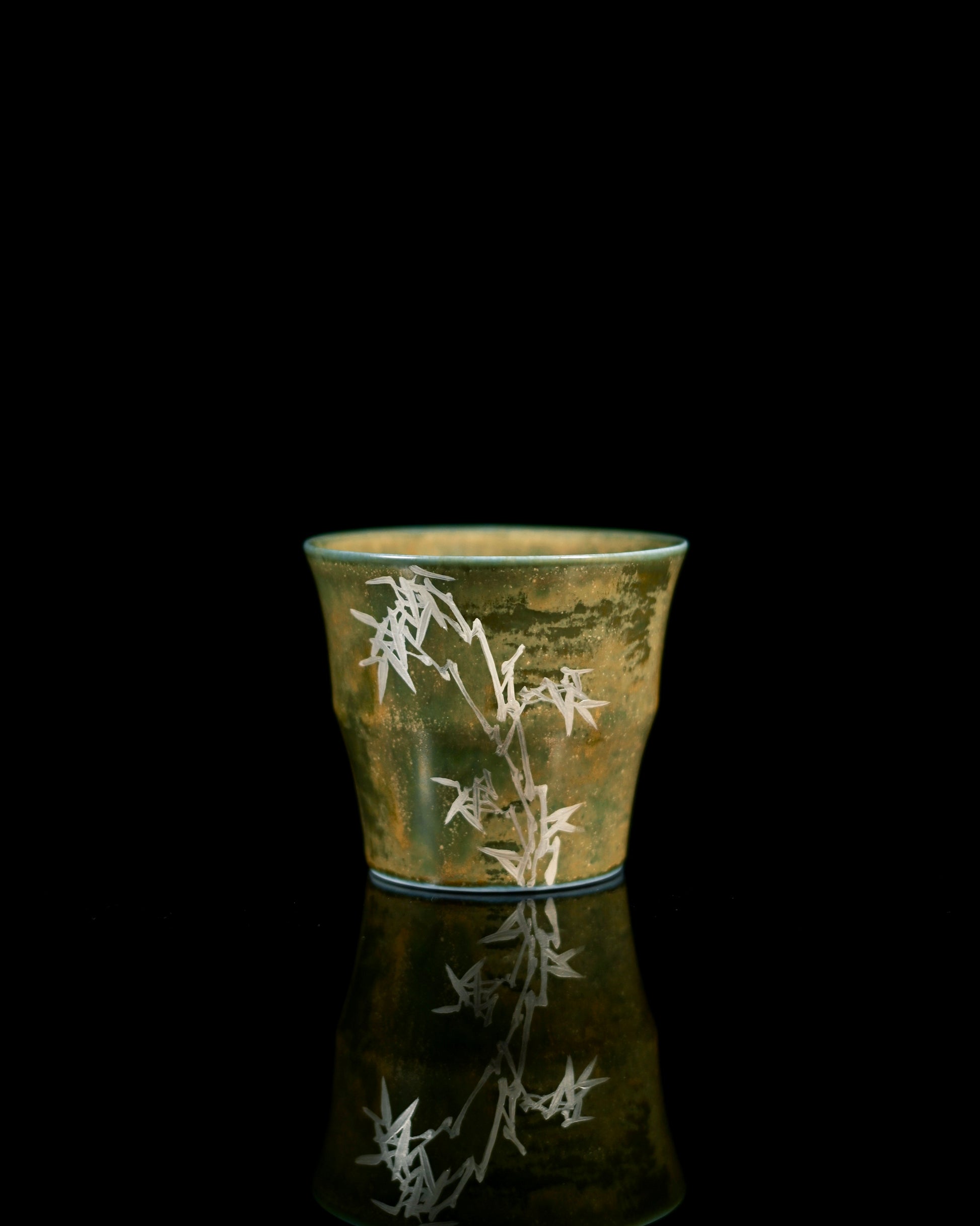 Reverse side of the Bamboo Rhythm teacup, showing the studio's stamped signature mark and proof of Jingdezhen origin