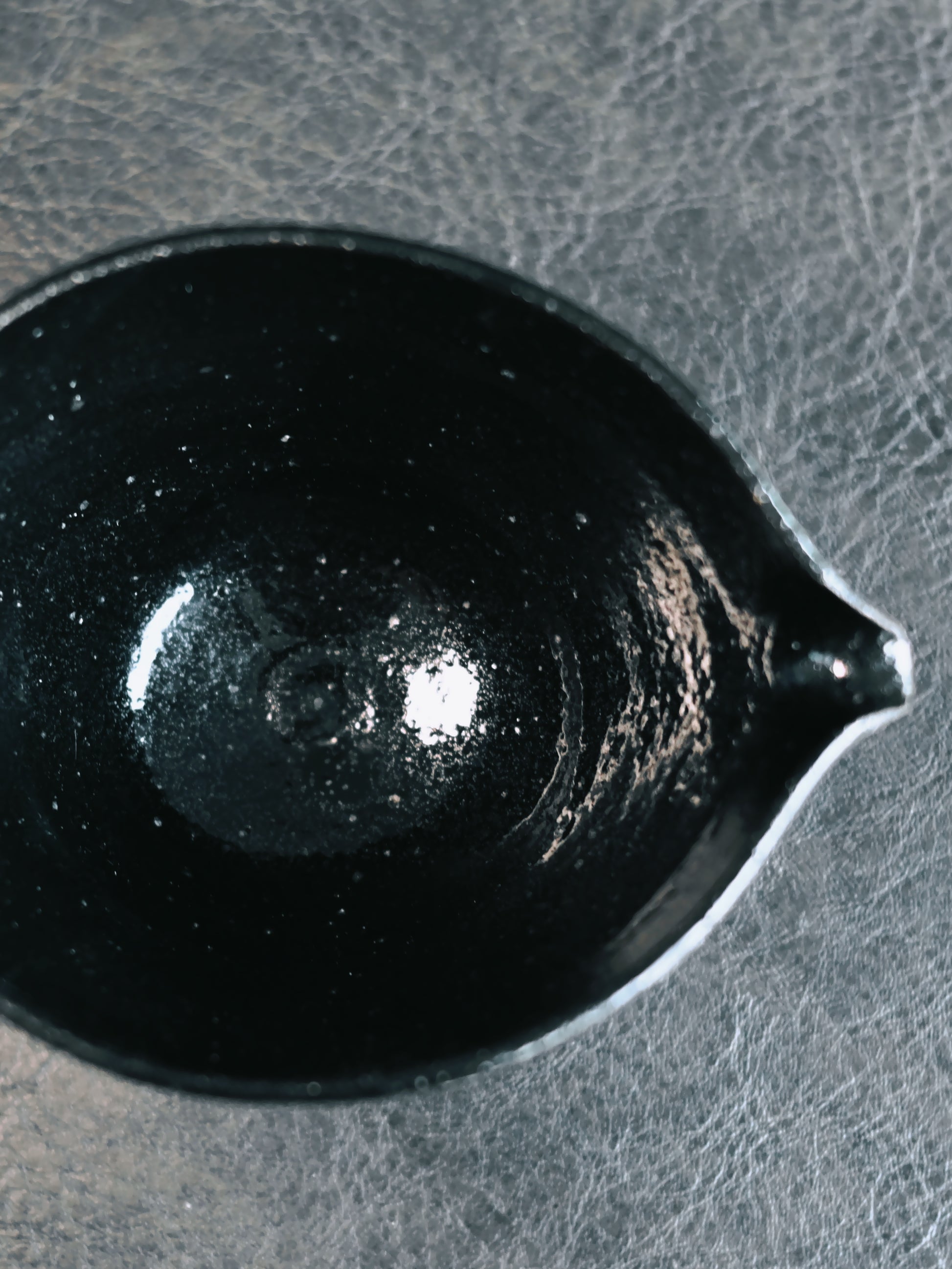 Wabi-sabi tea set in glossy black glaze with hand-painted silver poetry and pine motifs, embracing imperfect beauty in Japanese tea ceremony style.