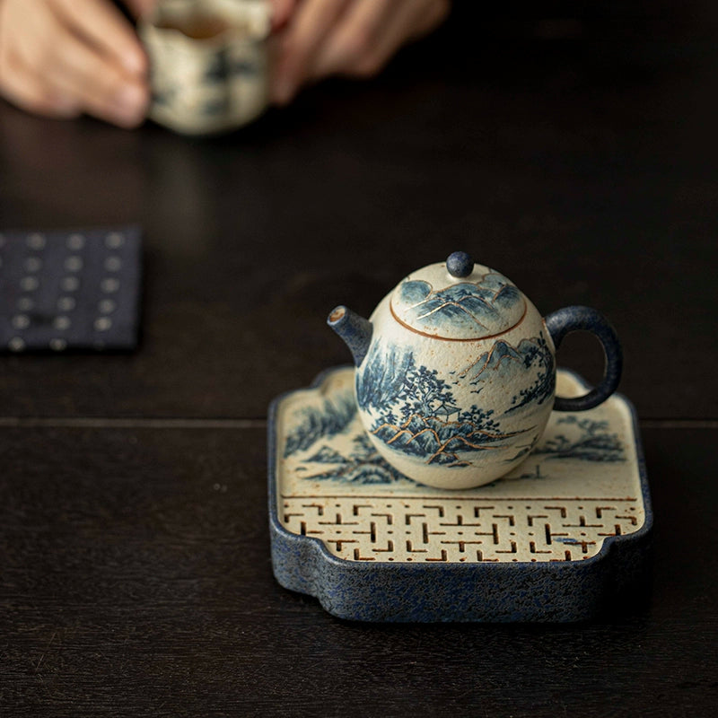The delicate cobalt brushstrokes tell stories of misty peaks and distant rivers. Each teapot is a unique canvas, shaped like a dragon egg — graceful, symbolic, and full of spirit.