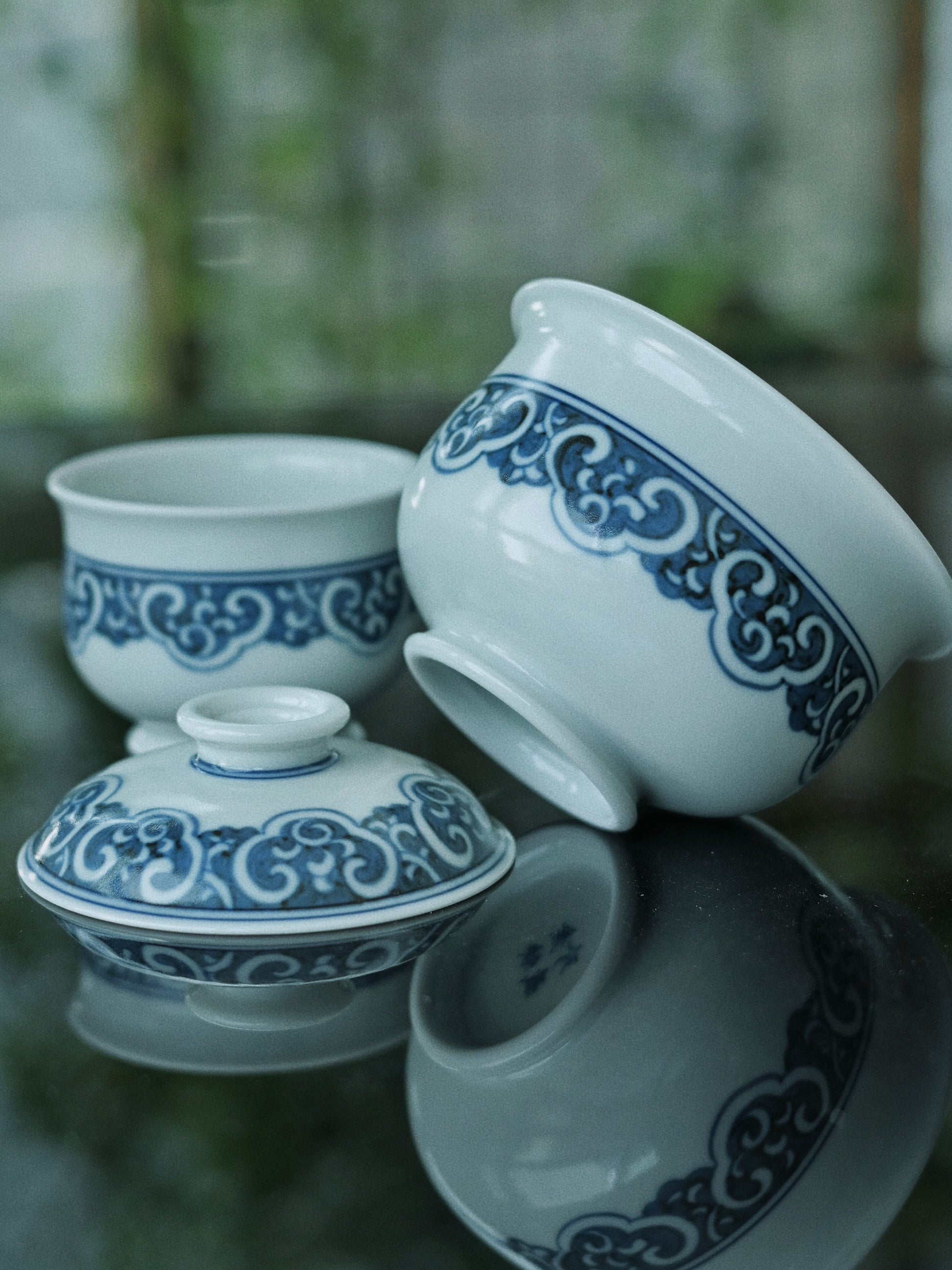 Authentic Jingdezhen gaiwan set featuring transformed imperial motifs: ruyi borders, key-fret designs, and hidden Eight Treasures symbolism in cobalt blue on white porcelain.