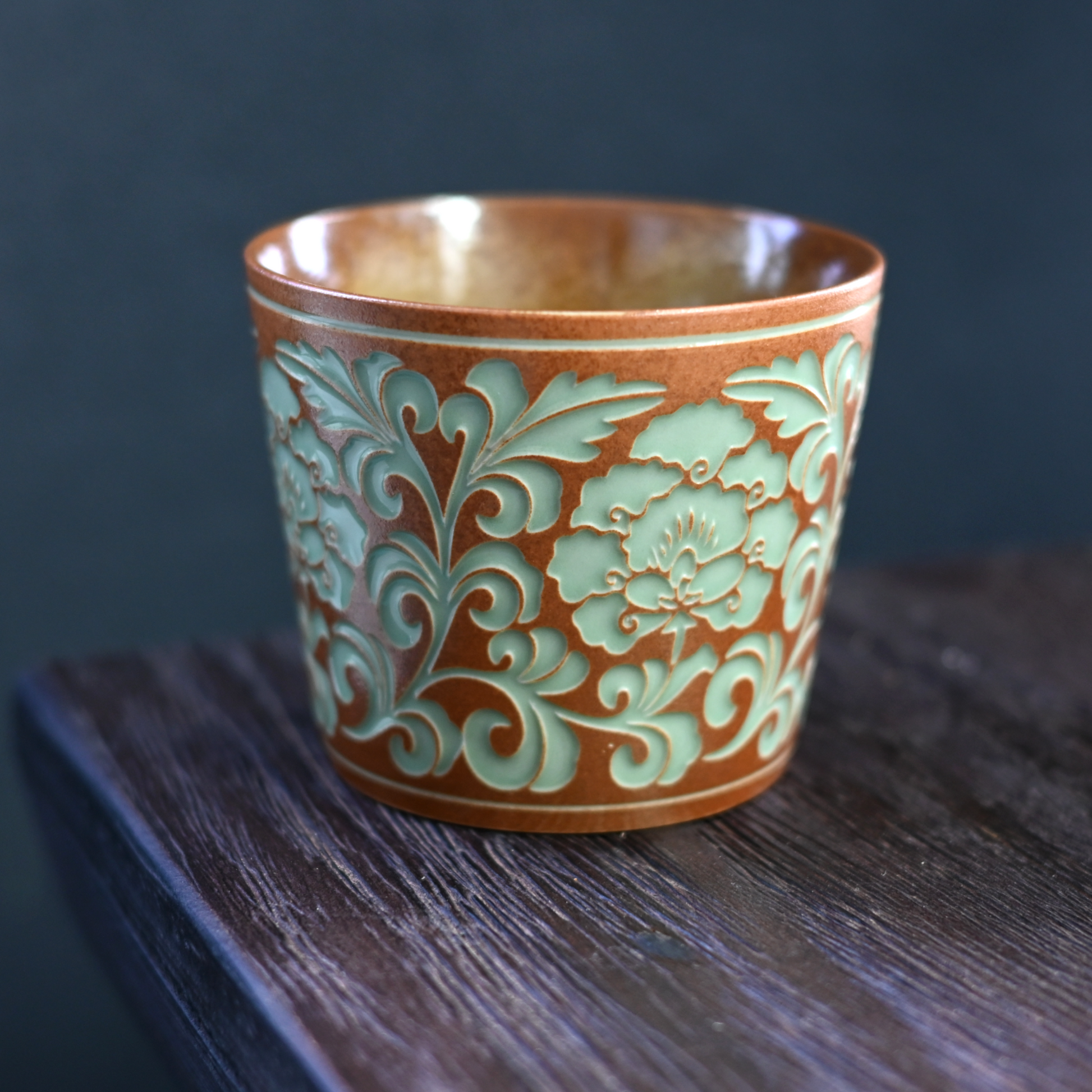 Textured peony vine carving provides secure hold on this Longquan celadon mug, featuring plant ash glaze and versatile 260ml size.