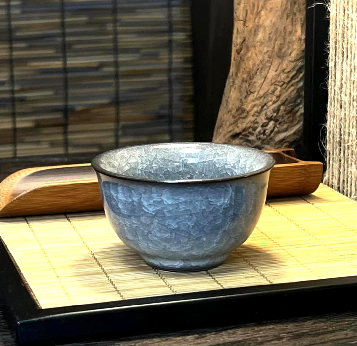 Classic Chinese tea cup in Longquan celadon with ice crackle glaze and ergonomic ya shou base design