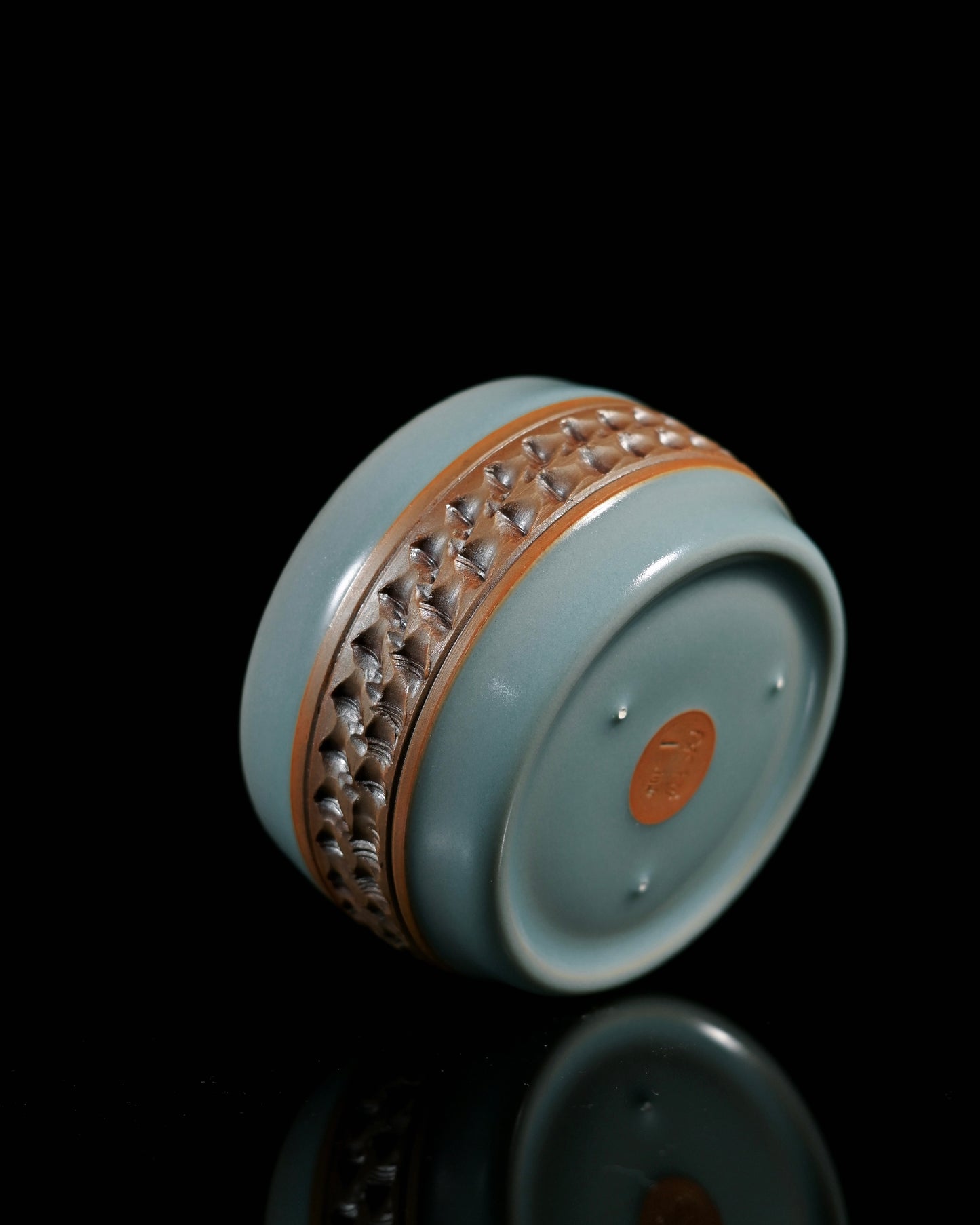 Ash clay Ru porcelain cup showcasing jumping-knife carving patterns and traditional pin-mark firing technique