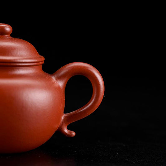 Original Dingshu Town Zisha pottery in warm rust-red vermilion clay with natural grain texture