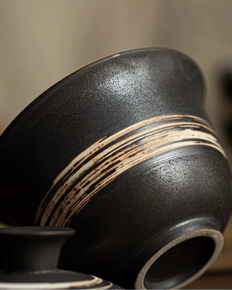 Handmade tea bowl with rustic charm, featuring intentional imperfections and natural clay coloration