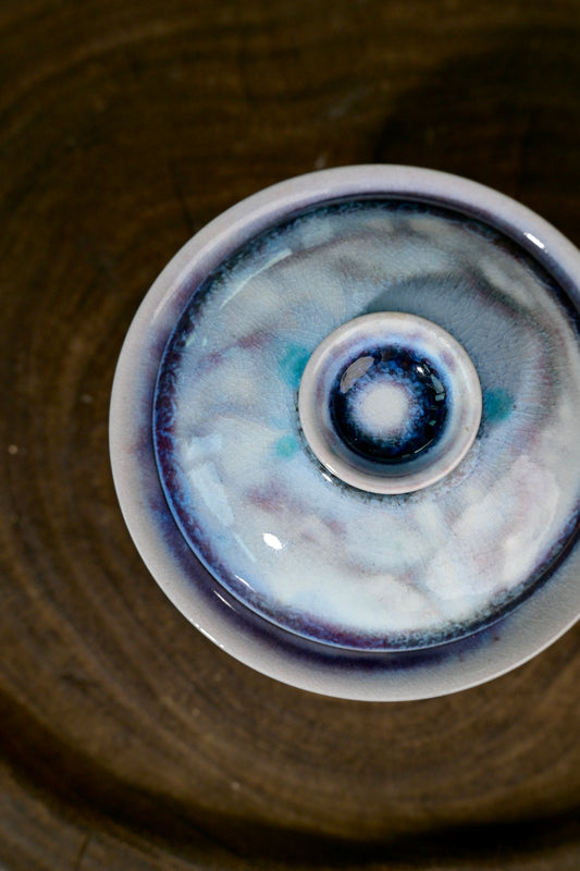 Close-up of soda kiln amethyst purple glaze crystallization and sapphire blue tones on 80ml gaiwan