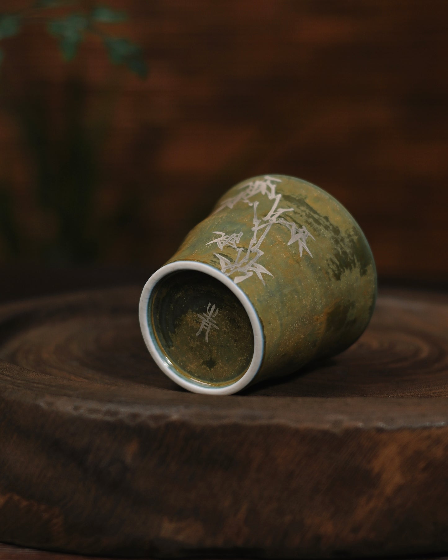 Delicate silver gilted bamboo decoration captured in natural daylight, highlighting its subtle metallic sheen against the matte glaze
