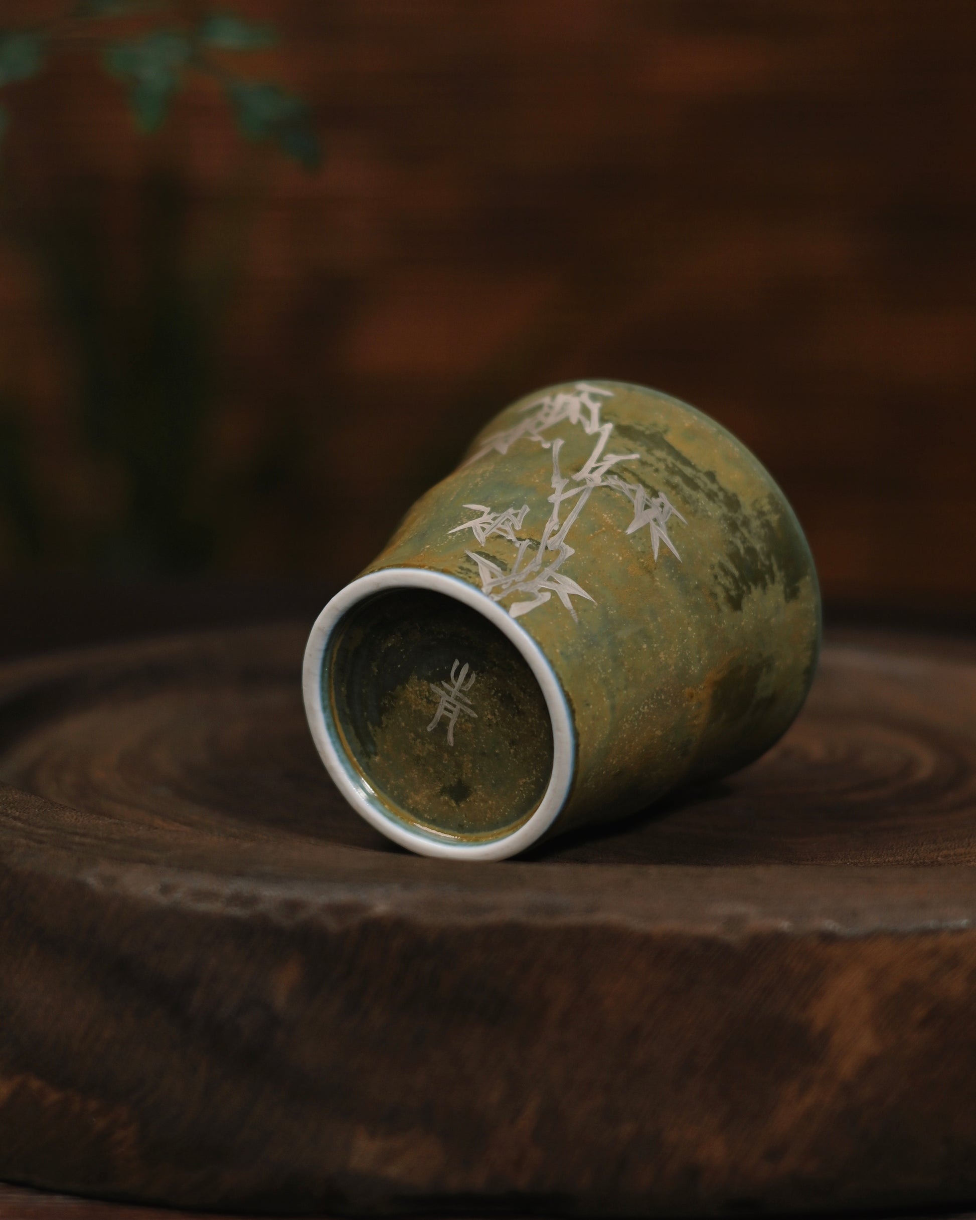 Delicate silver gilted bamboo decoration captured in natural daylight, highlighting its subtle metallic sheen against the matte glaze