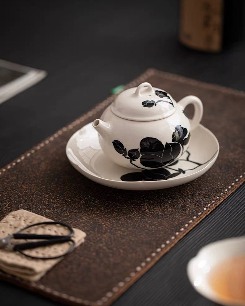 Gray-white ash glazed teapot with contrasting black magnolia motif and minimalist design