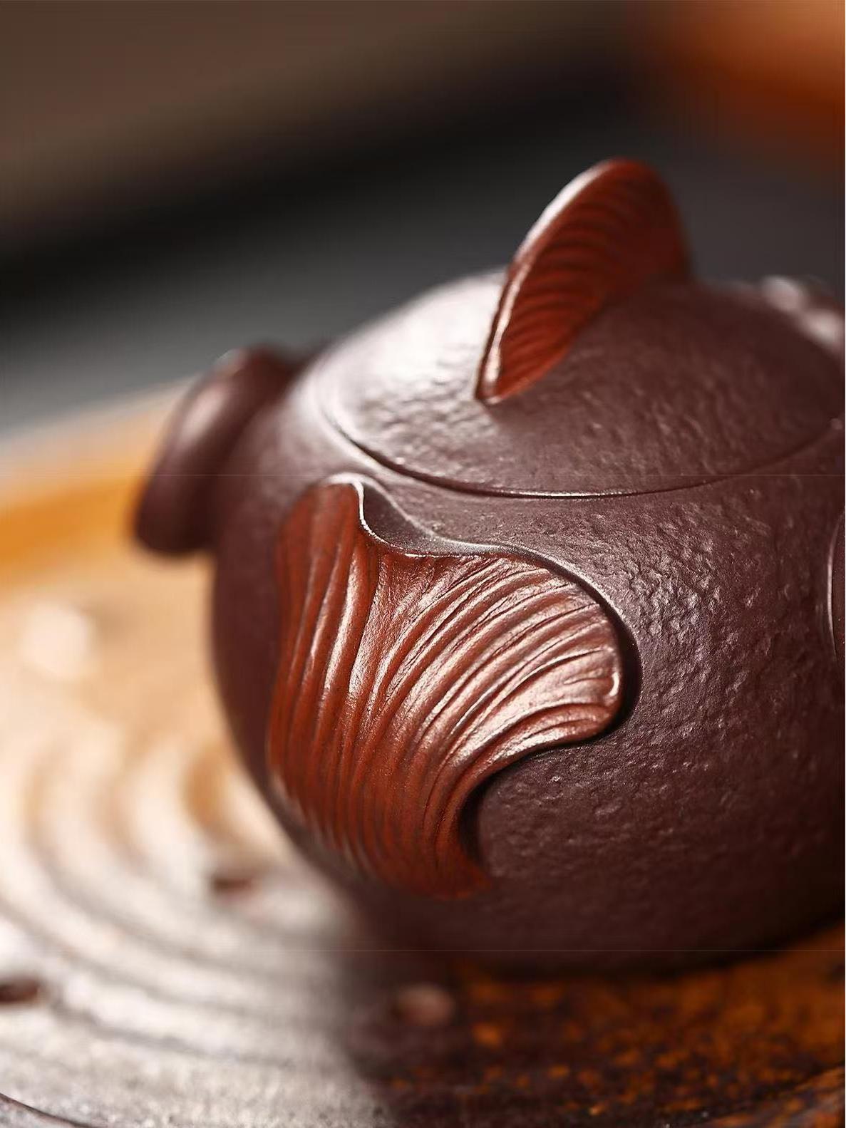 Handcrafted Yixing purple clay pufferfish teapot with realistic detailing, 7-hole filter, and smooth pouring spout - functional art for tea lovers.