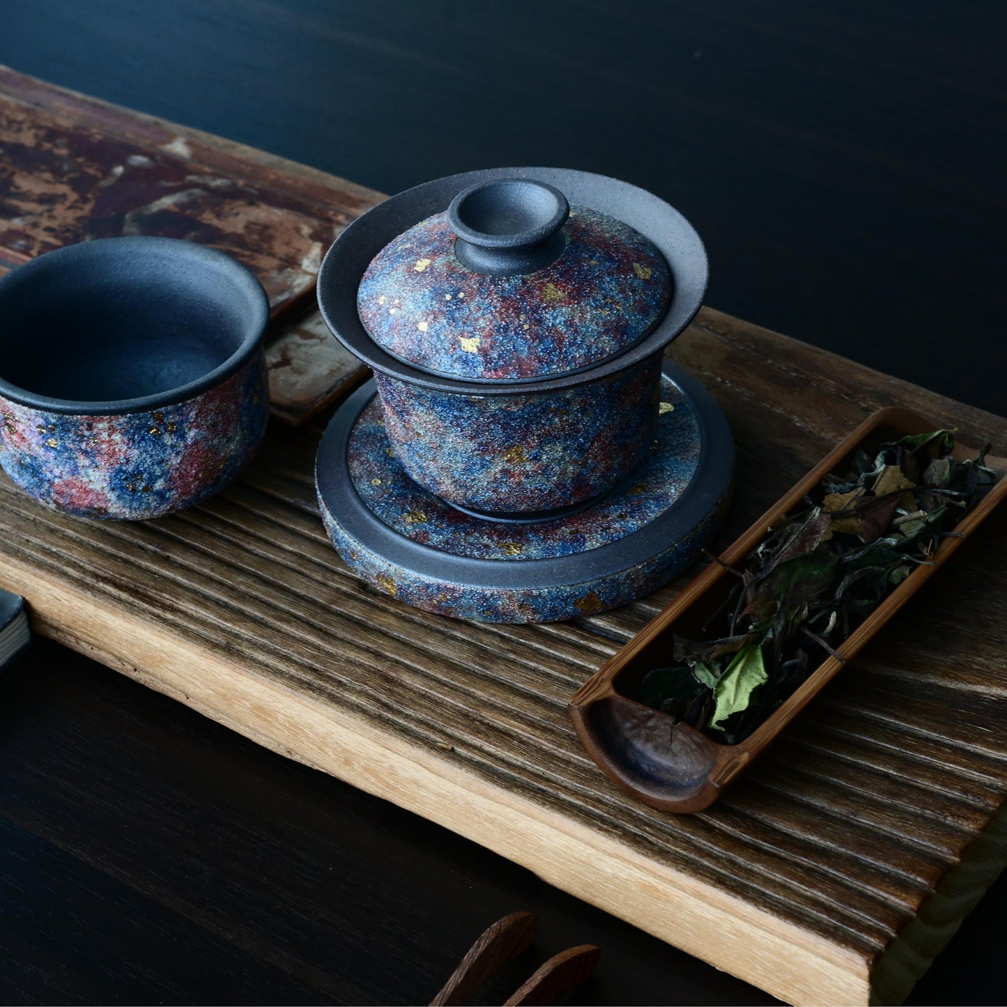 Luxury Yixing gaiwan featuring mineral gold decoration on aged purple clay, engineered to elevate both oolong and pu-erh tea experiences - the perfect connoisseur's gift.