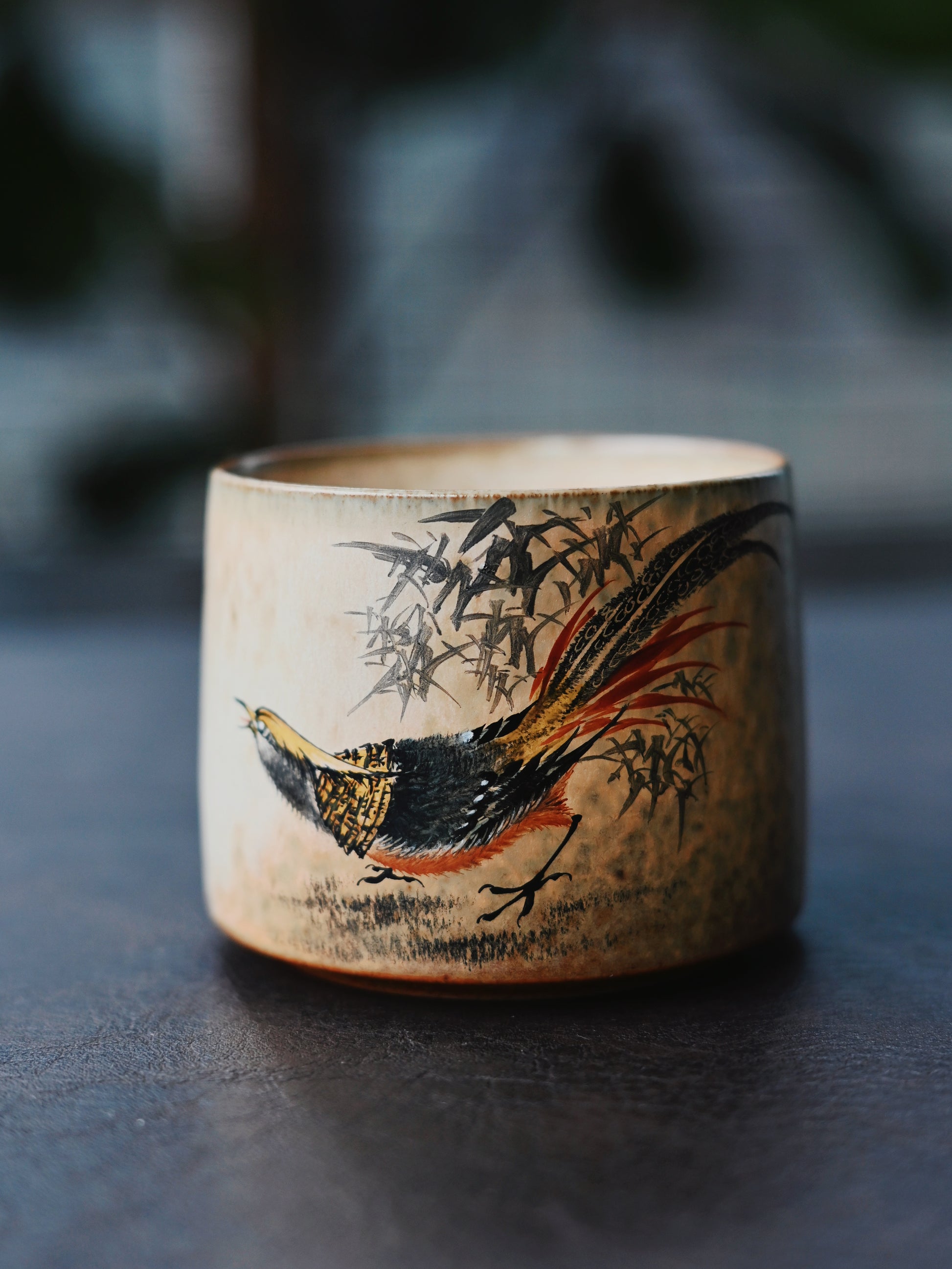 Museum-quality Jingdezhen cup demonstrating complete handmade process - from wheel-throwing to detailed Chinese bird-and-flower painting in vintage palette.