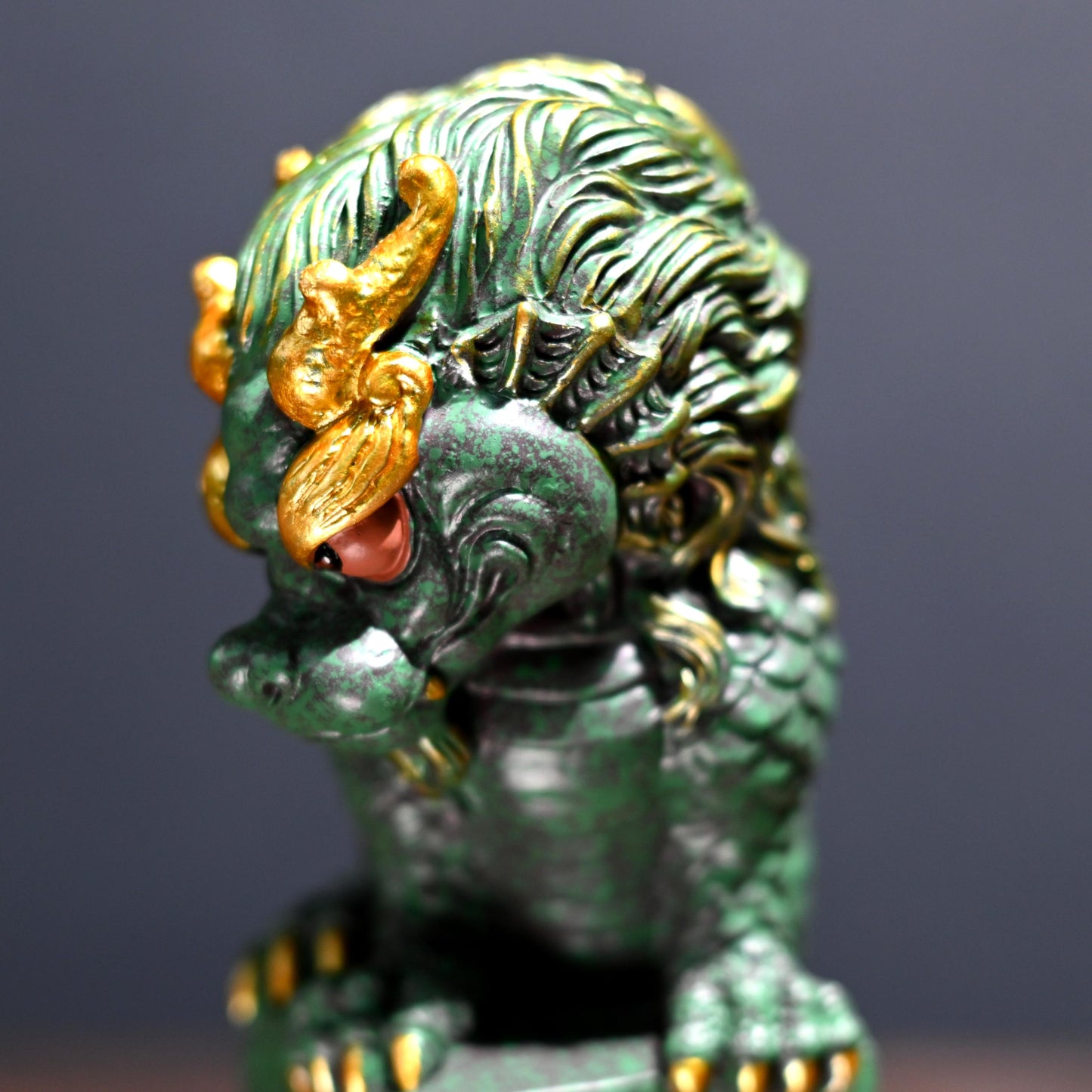 Hand-carved coiling dragon ornament in green sandstone with gold decoration for tea tables