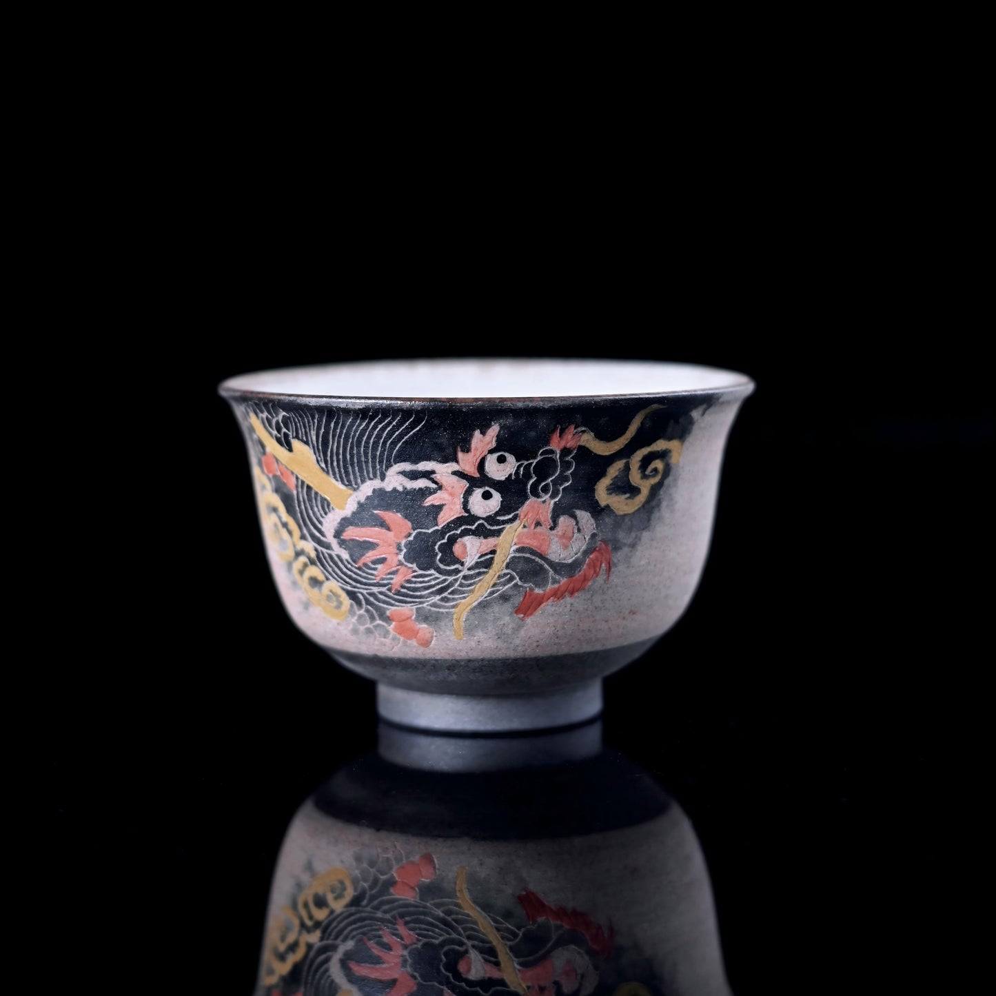 Handcrafted Jingdezhen porcelain teacup by Saanwu Studio, featuring intricate hand-carved dragon design for Chinese tea ceremonies.