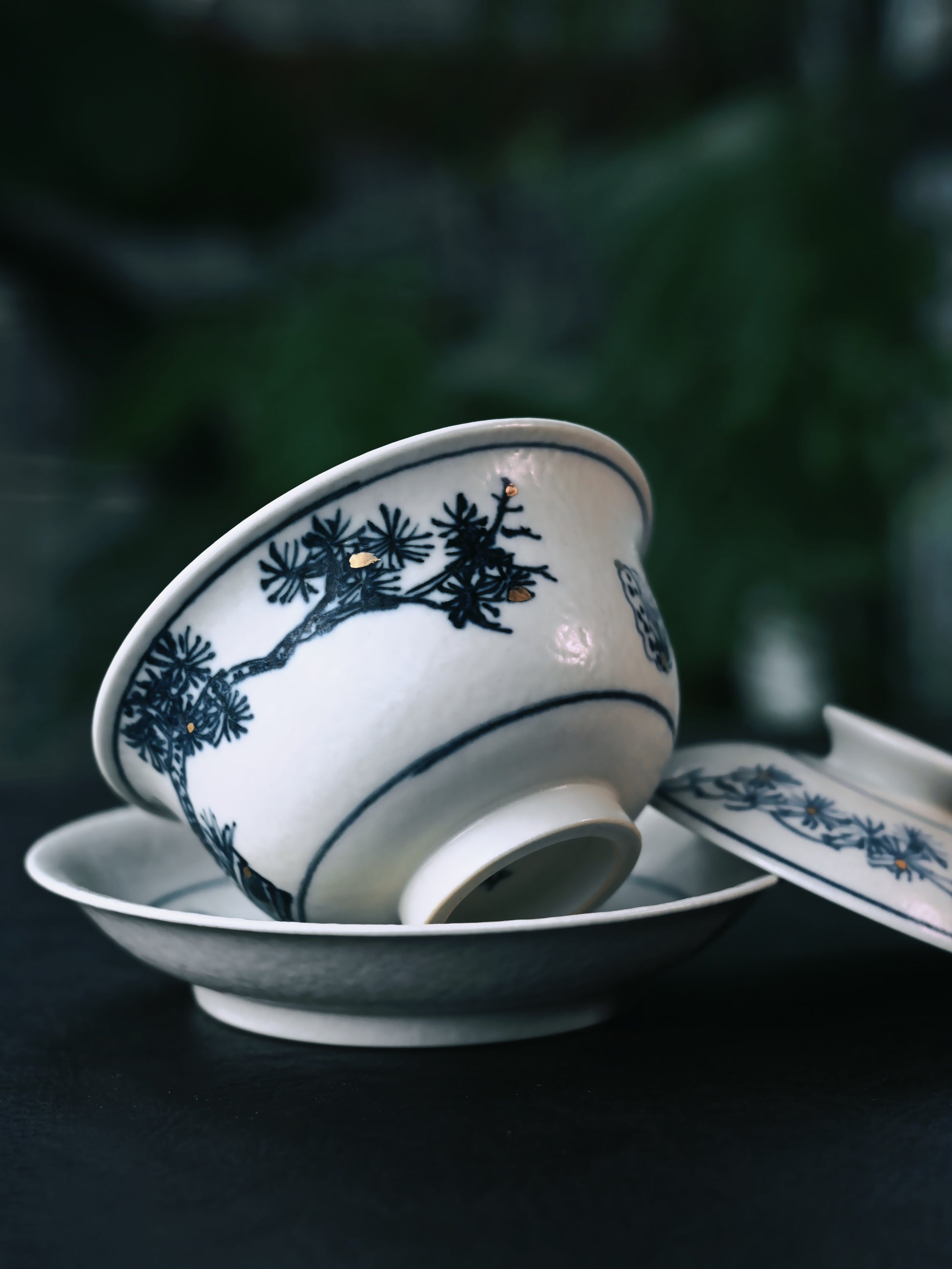 Premium kaolin clay gaiwan with Jingdezhen's signature blue and white pine pattern under matte glaze, fully handcrafted in traditional three-part construction.