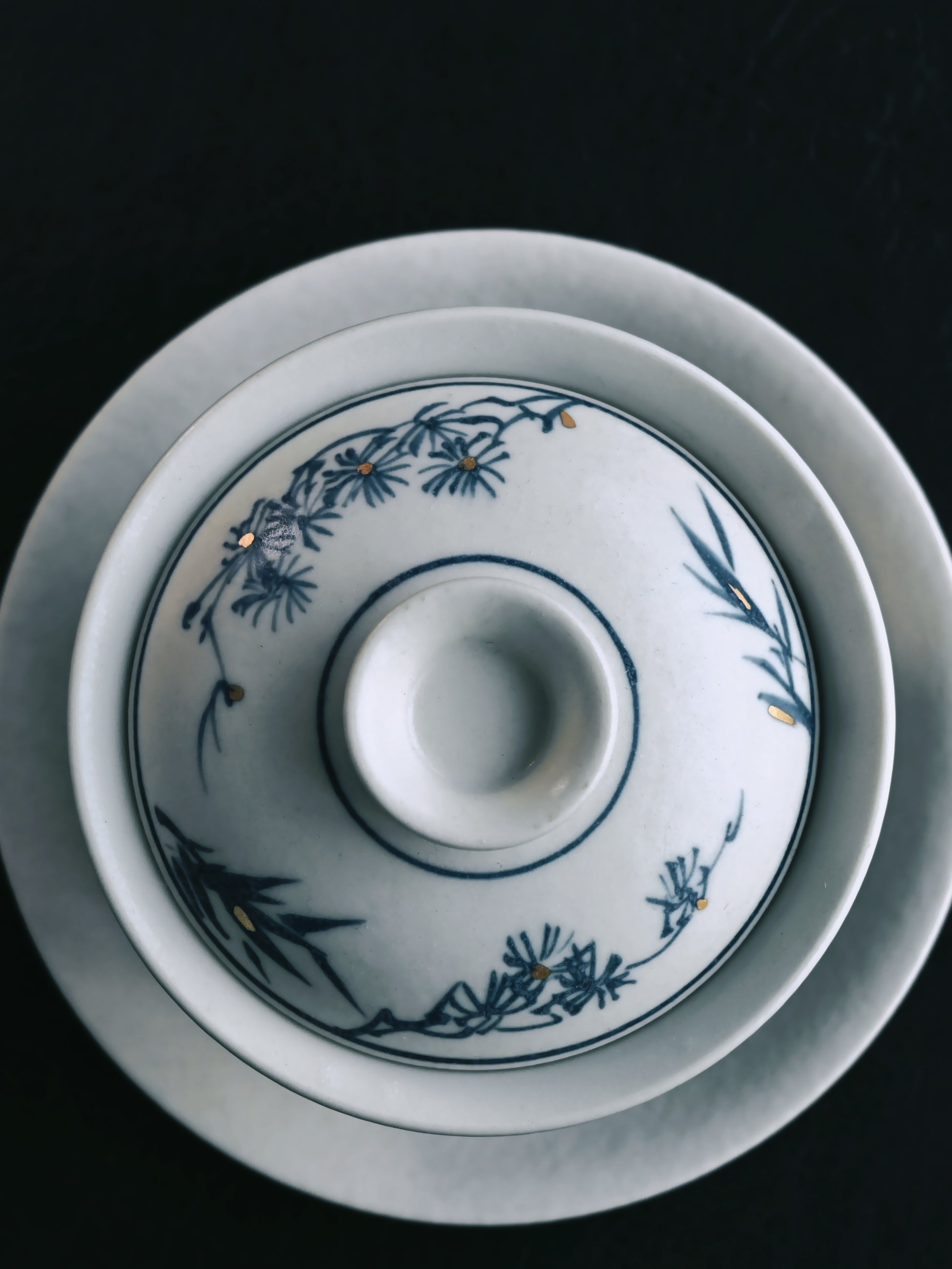 Matte-finished blue and white gaiwan featuring traditional pine motif brushwork, hand-built in Jingdezhen using pure kaolin clay in the classic three-part 'heaven-earth-man' form.