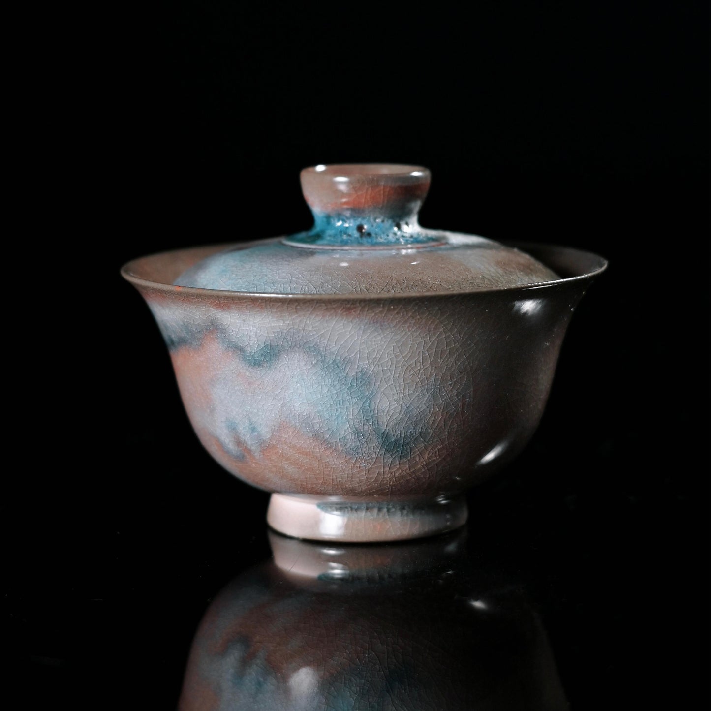 Jingdezhen wood-fired gaiwan with crystalline glaze resembling shimmering galaxy patterns and natural crackle texture
