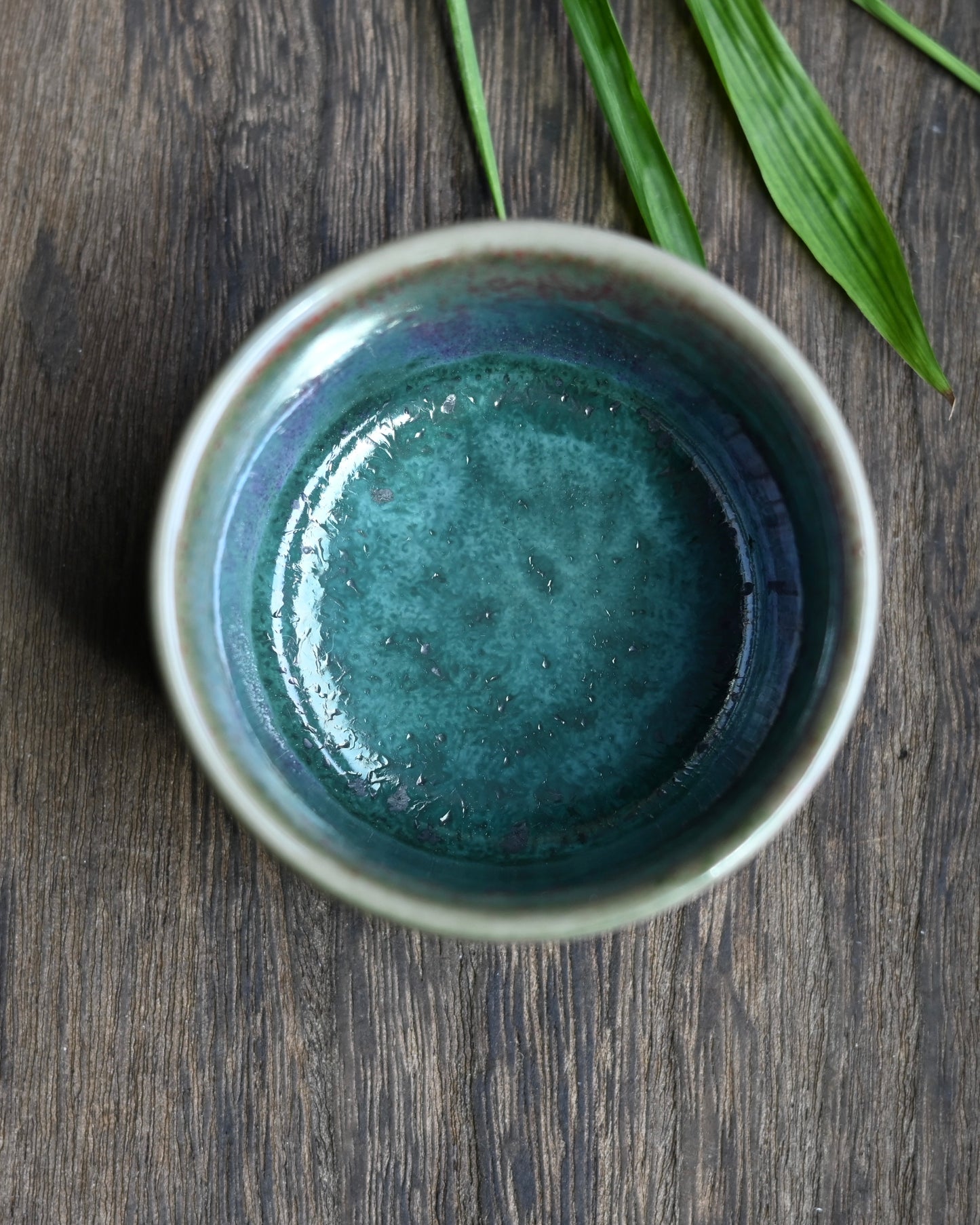 Handcrafted Jun ware teacup with magical green flambé glaze, horsehoof shape, and crackled texture for Chinese tea ceremony