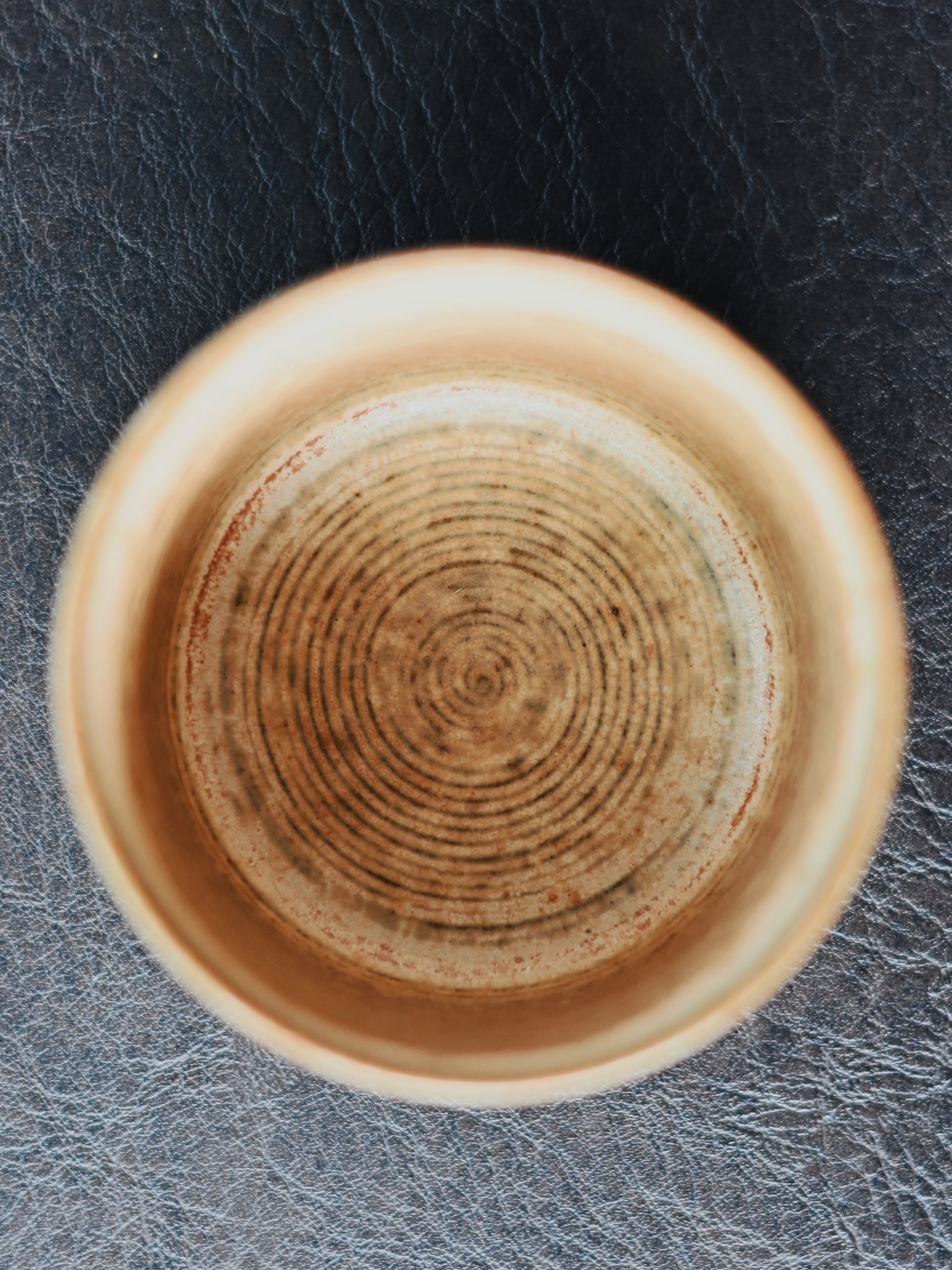 Hand-coiled porcelain cup with detailed Chinese brush painting of birds and blossoms, crafted using traditional Jingdezhen techniques for a nostalgic aesthetic.