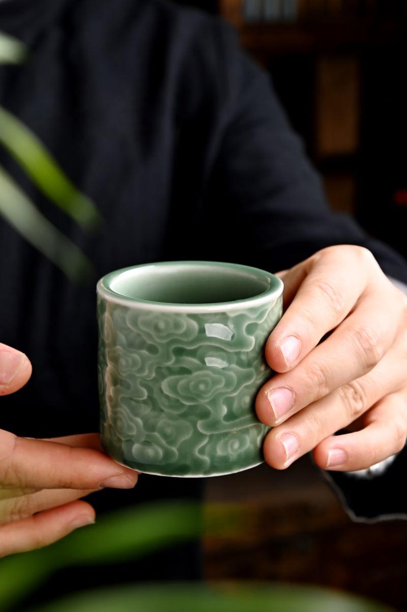 A masterpiece of tradition – the Longquan Celadon Cloud Embossed Cylinder Cup.