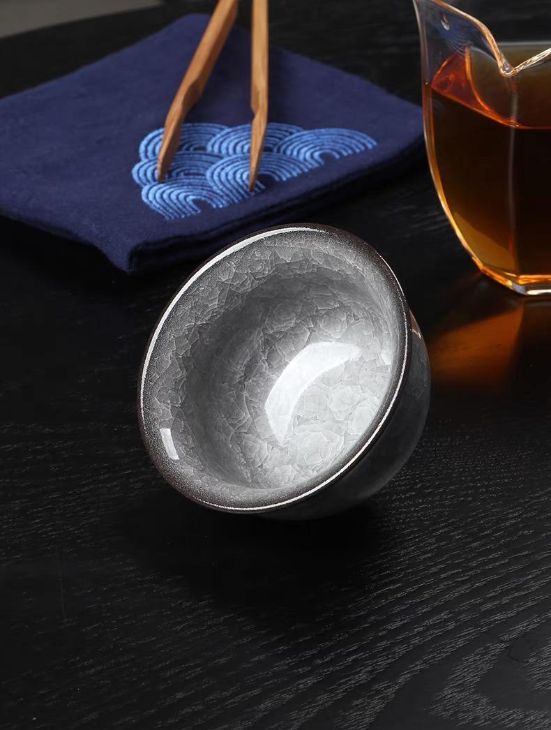 Longquan celadon press-hand cup with ice crackle glaze, designed for perfect balance and comfortable tea drinking experience