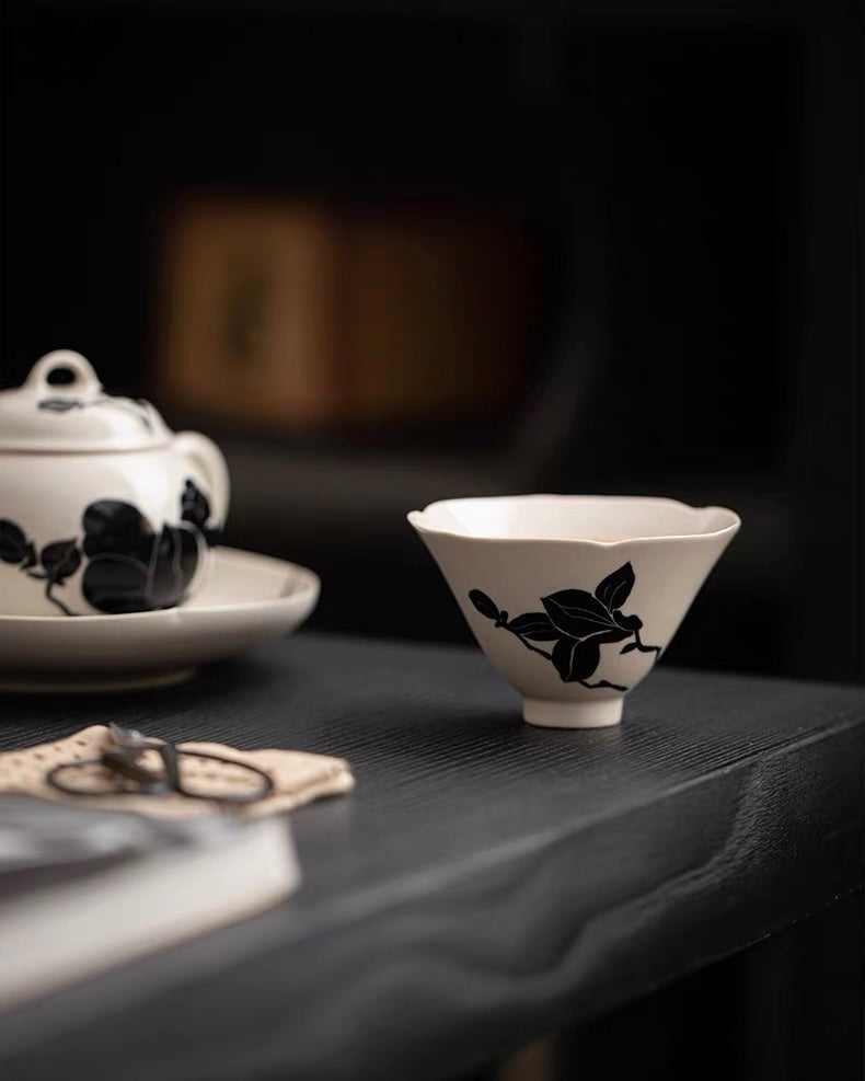 Ceramic tea cone with gray-white glaze gradient, highlighting black magnolia silhouette