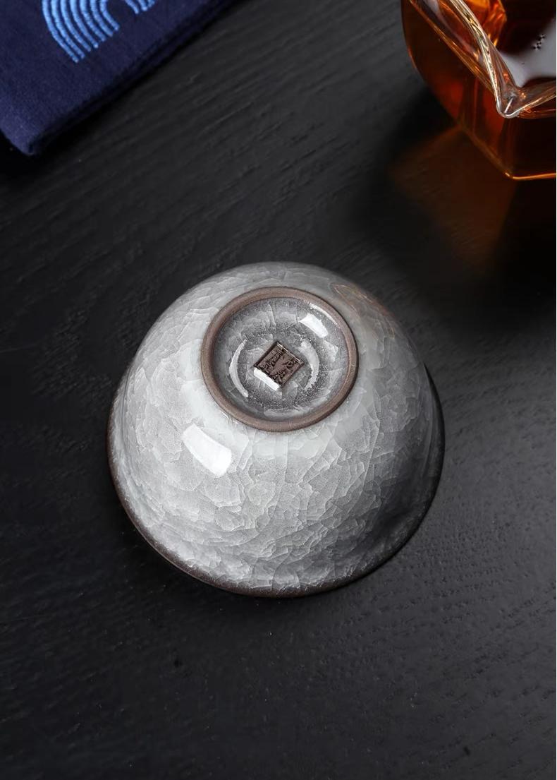 Premium Longquan celadon tea cup featuring ice crackle glaze and traditional weighted ya shou form