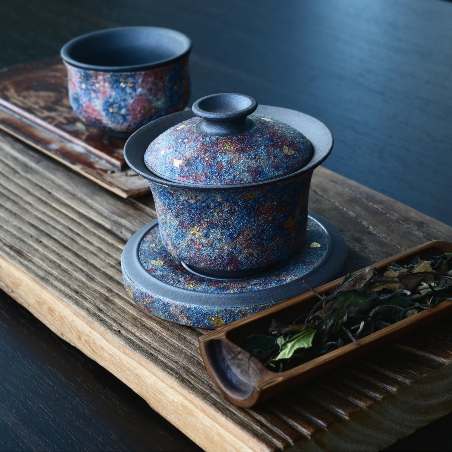 Gift-grade Yixing gaiwan with gold accents, crafted from antique purple clay to perfectly complement oolong and pu-erh teas - where luxury meets functionality.