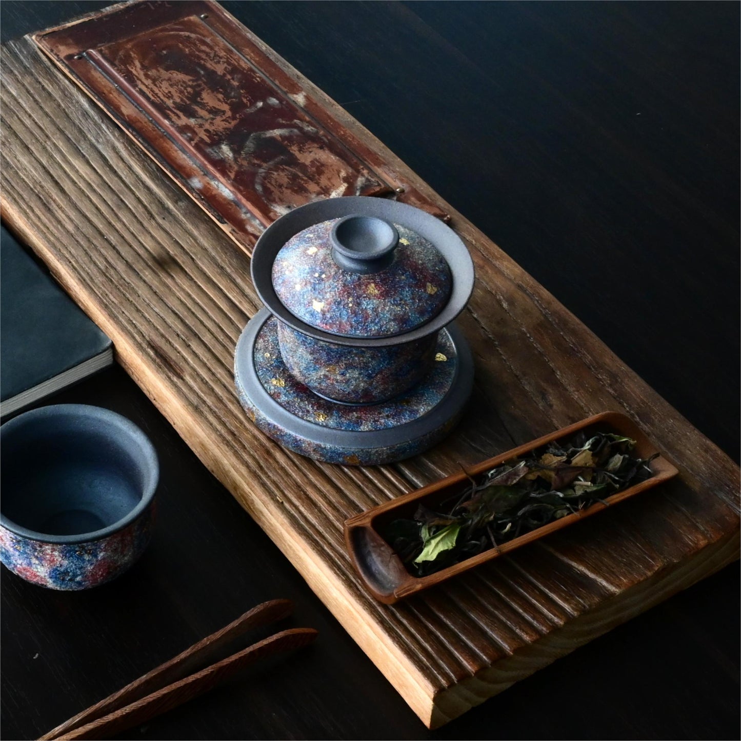 Luxury Yixing zisha gaiwan featuring gold mineral embellishments on antique purple clay, presented as an elite gift for tea ceremony enthusiasts.
