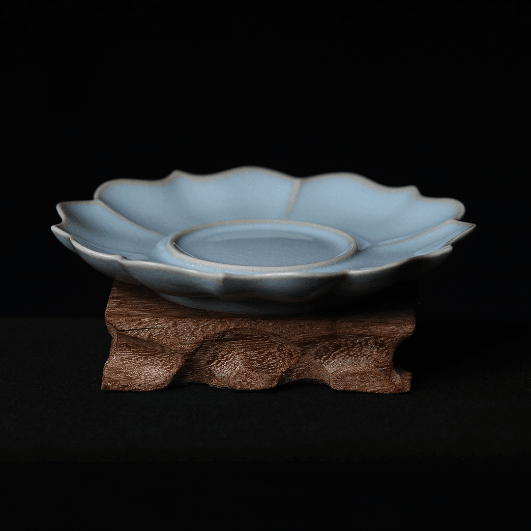 Imperial-inspired ceramic saucer with sunflower petal border and Ru-style crackle glaze, functioning as elegant teacup base