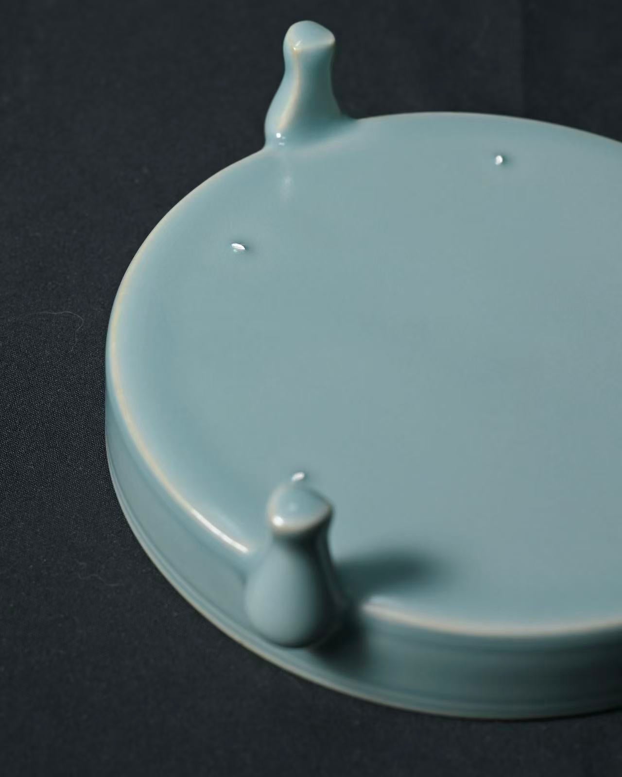 Precision-fired Ru ware stand requiring exact temperature control to achieve rare crackle-free celadon surface with authentic pin markings.