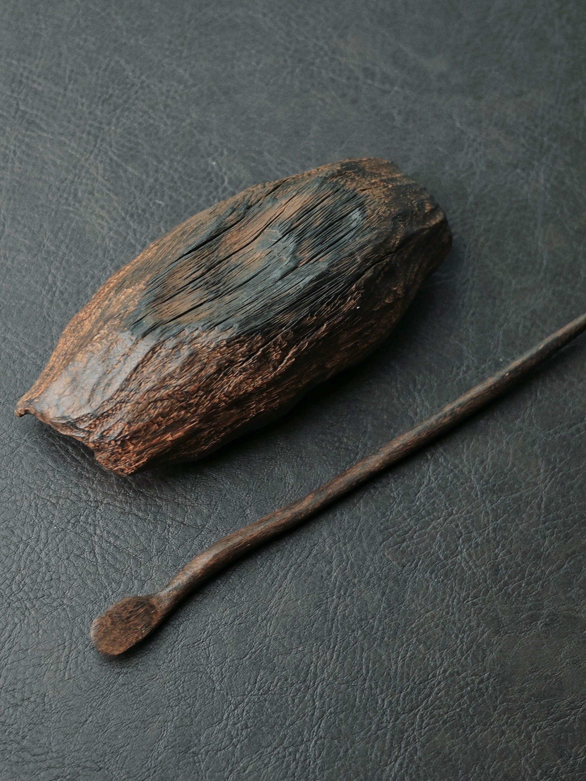Carbonized wooden tea scoop with handmade imperfections, showcasing natural wood characteristics