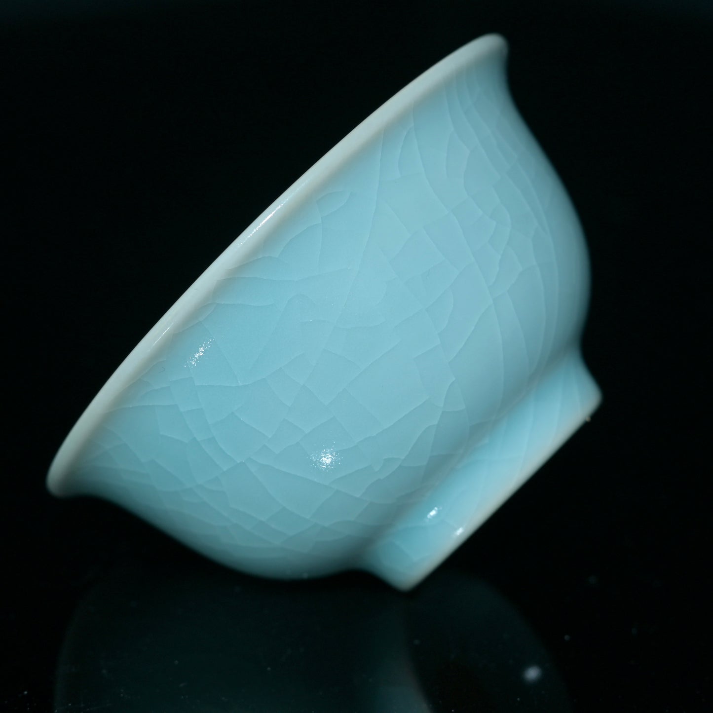 Traditional Chinese "Press Hand Cup" in Ru porcelain with sky-blue glaze and developing golden crackles over time.