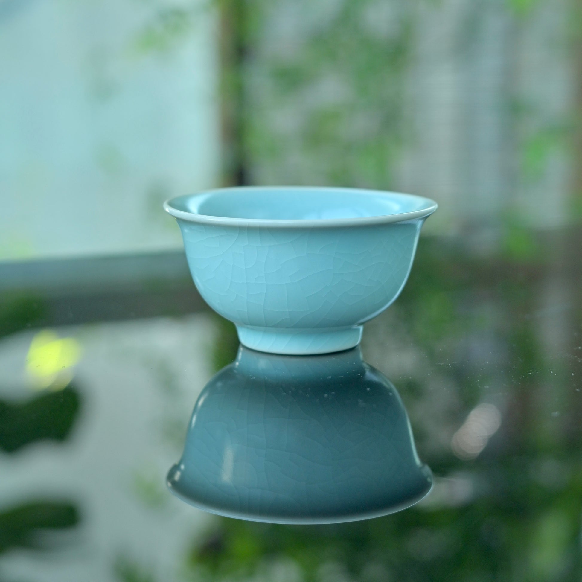 11th century inspired Ru porcelain cup with pure monochrome glaze, showing historical traces through tea use