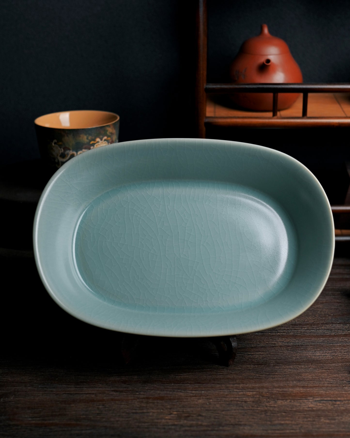 Traditional Ru ware oval basin with four legs and signature crackle glaze, serving as elegant pot stand or decorative object for tea spaces