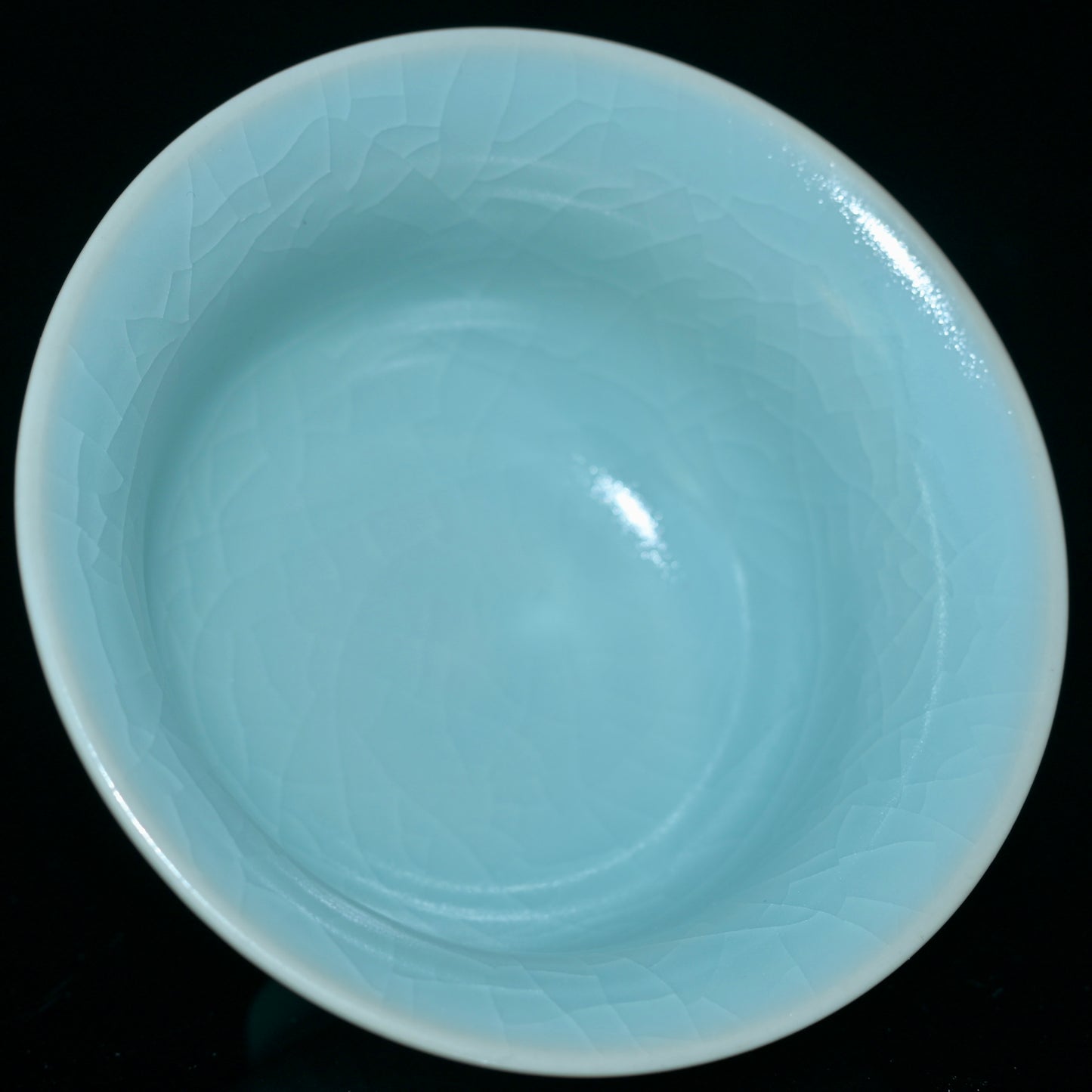 Song Dynasty style Ru porcelain tea cup with monochromatic glaze and evolving crackle patterns from tea soaking