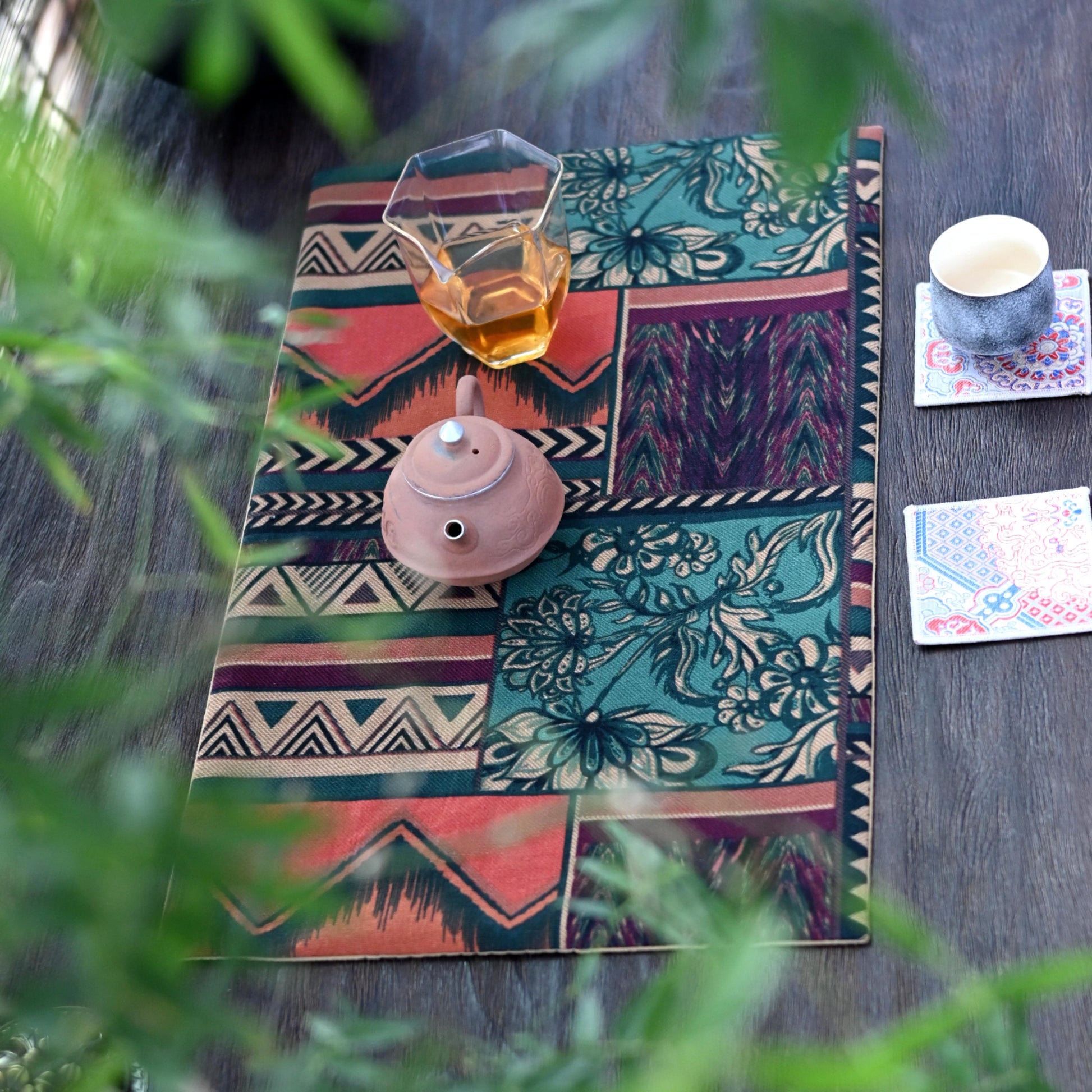 Retro ethnic patterned tea table mat, functional and stylish accessory.