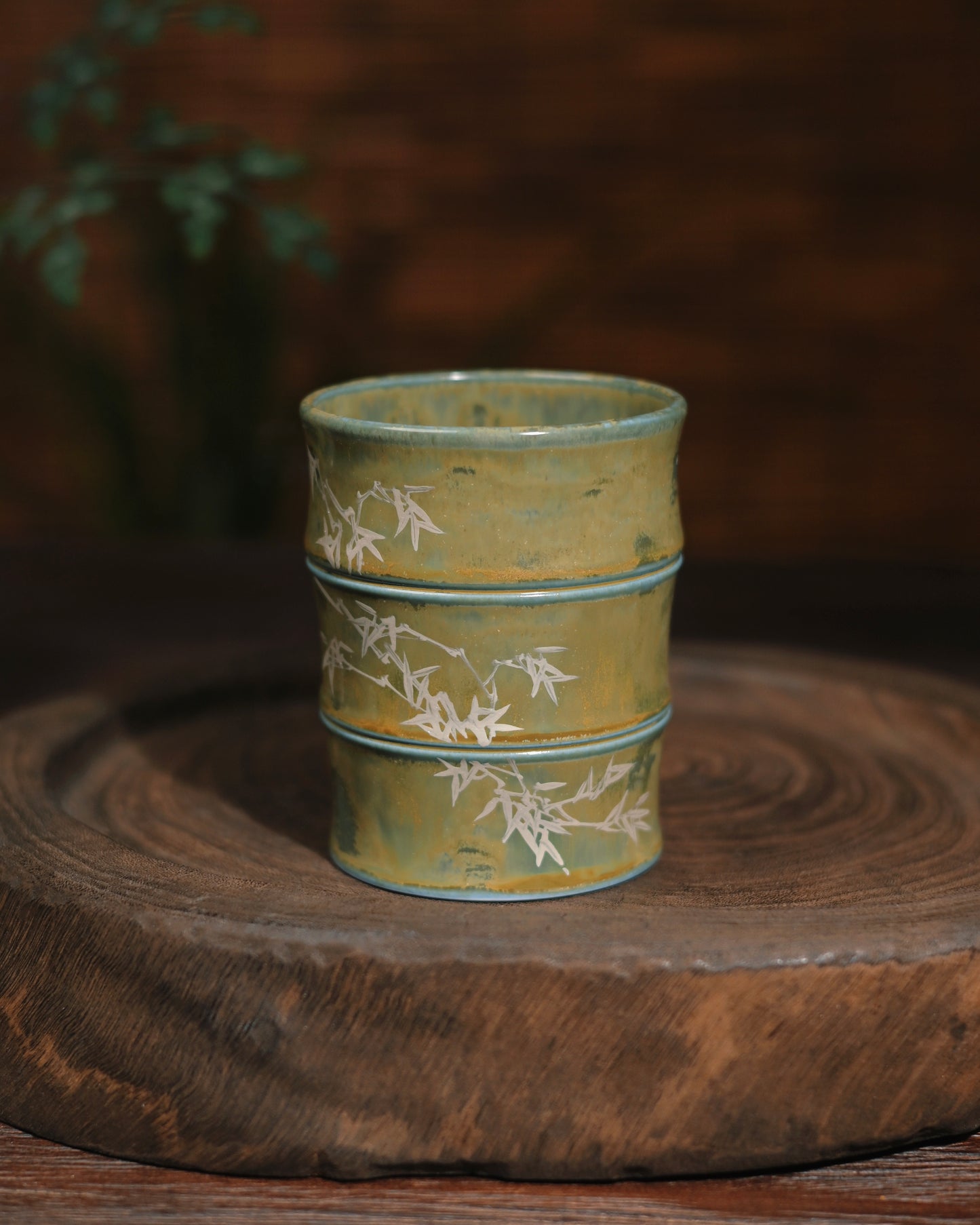 A curated collection of mugs from this Jingdezhen studio series, displaying variations in glaze effects and bamboo paintings