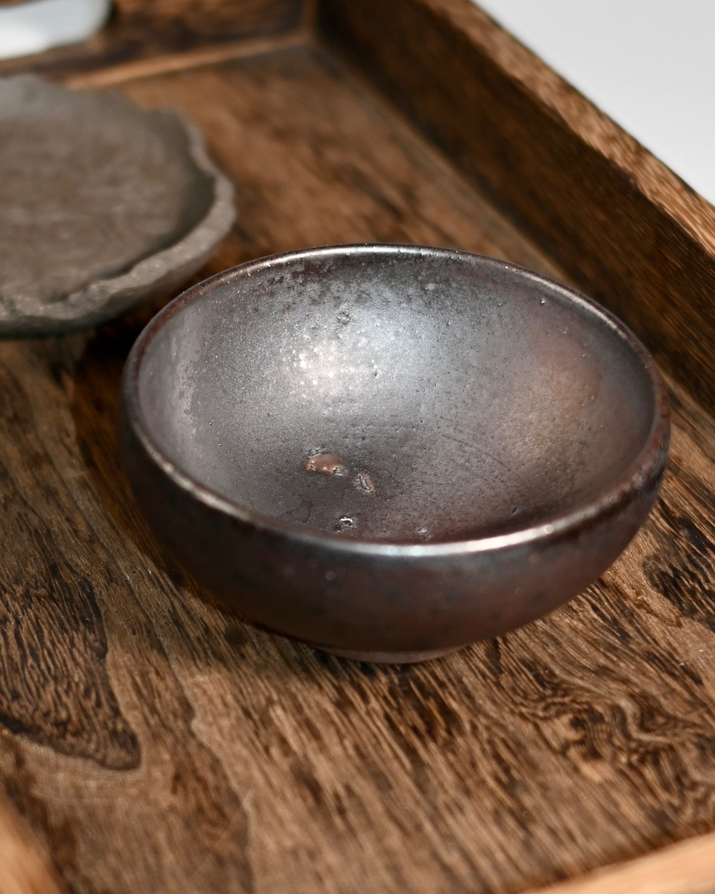 Natural tea patina development on unglazed clay through repeated use over time