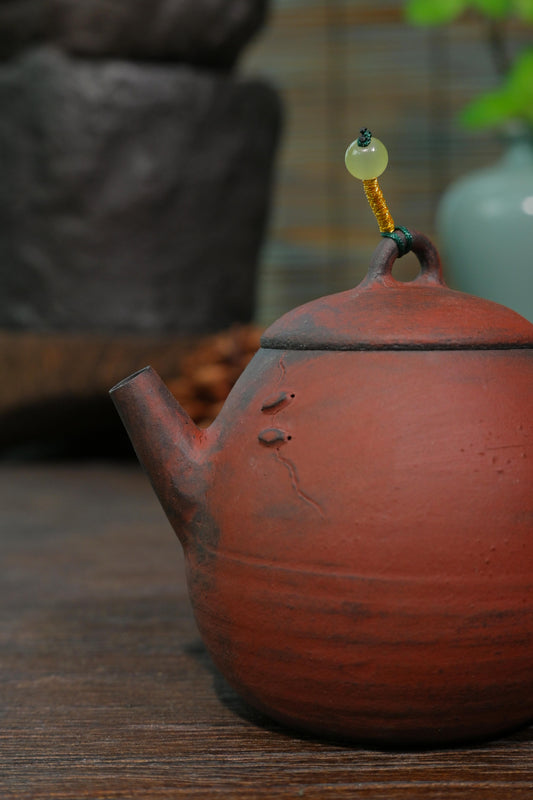 Stoneware 100ml iron clay tea pot with matte metallic sheen and raw clay texture from high-heat wood burn
