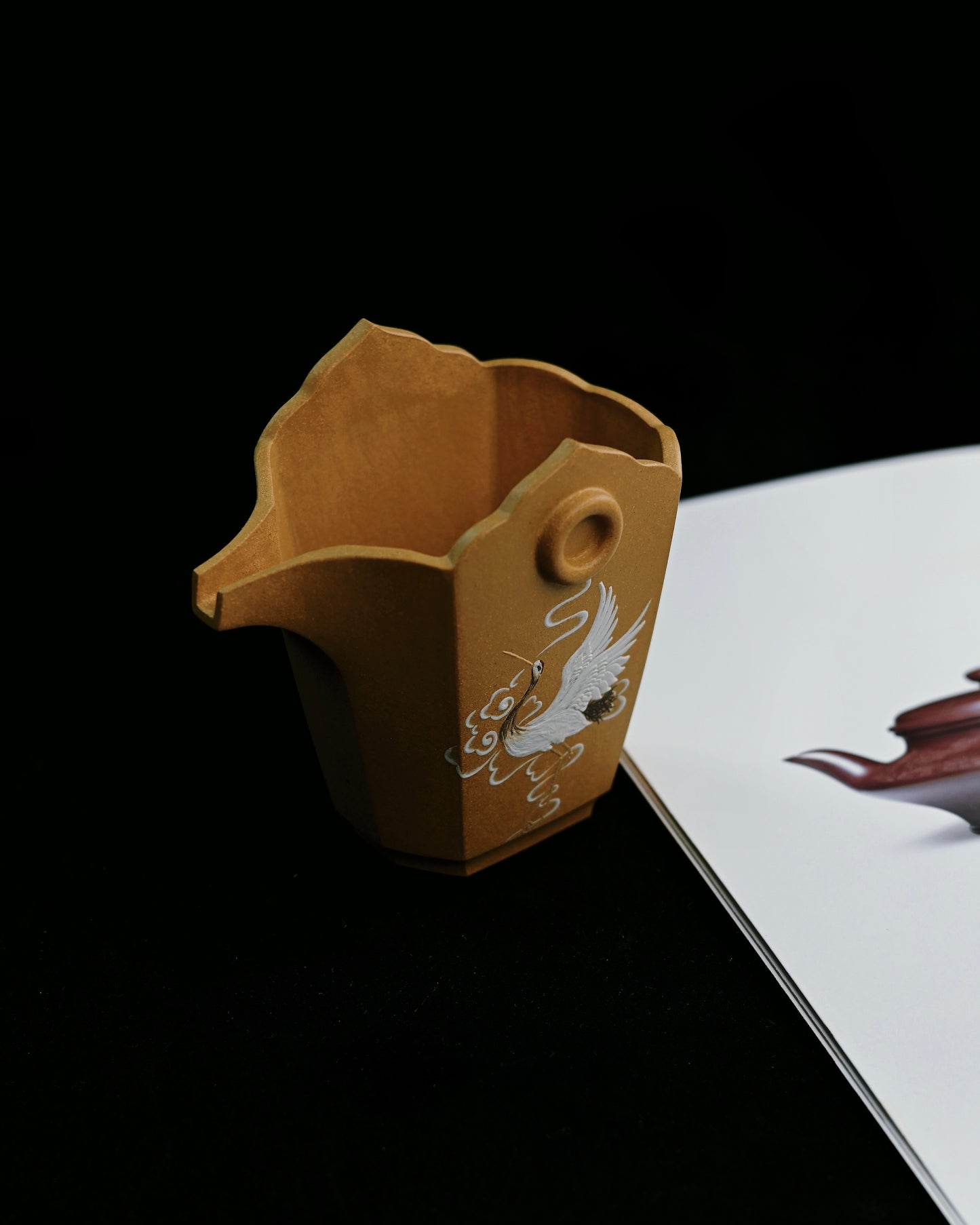 The justice cup in use, pouring tea gracefully during a traditional Chinese tea ceremony
