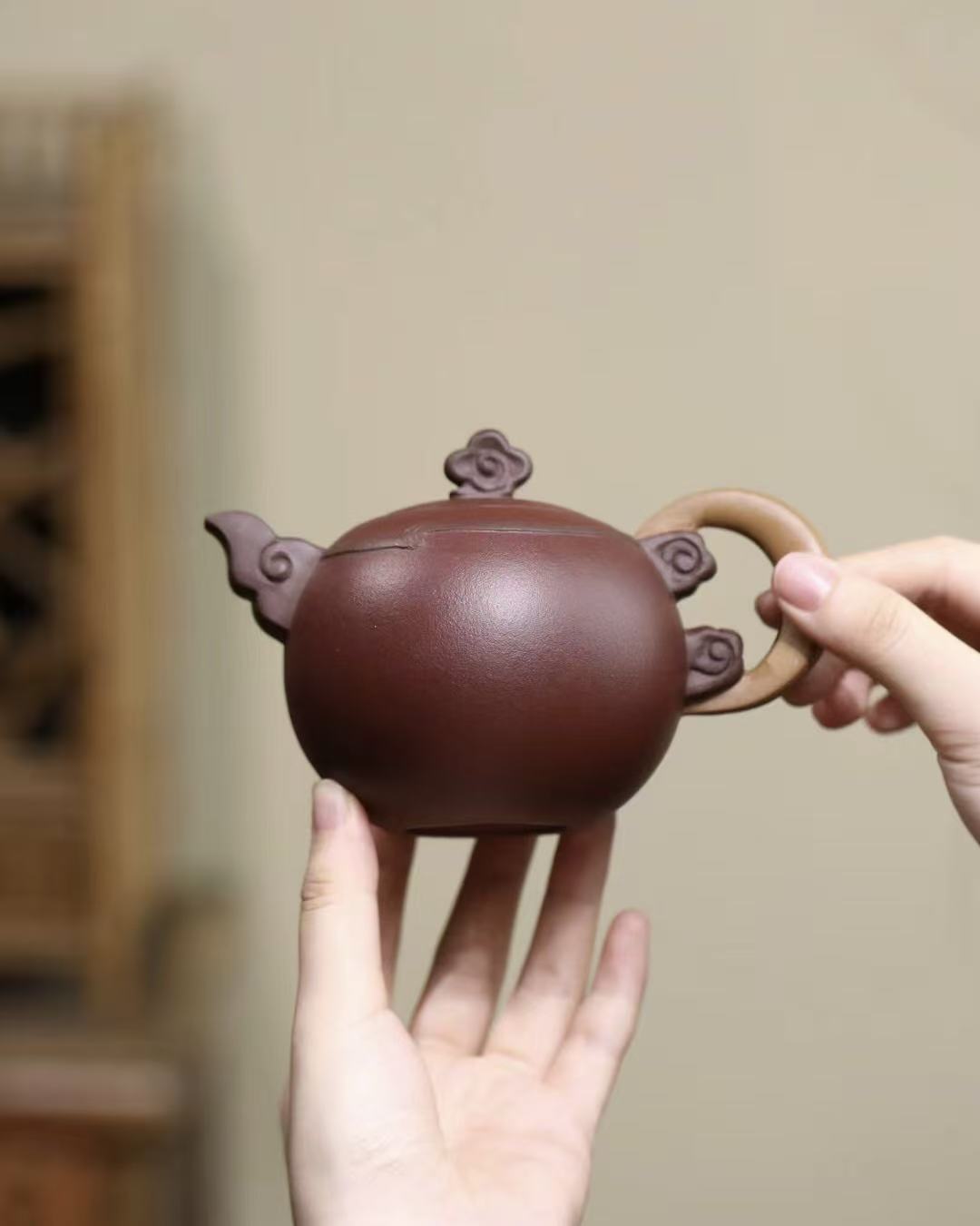 Yixing teapot showcasing artistic clouds and moon design in Zisha clay
