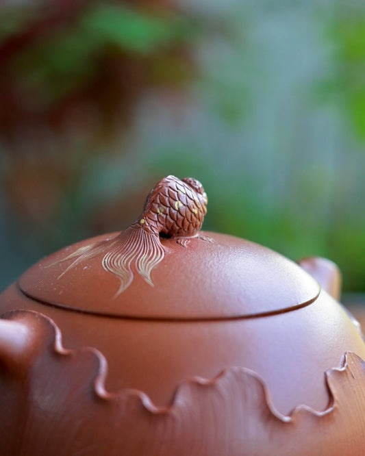 Yixing teapot lotus leaf wrapping lower section of teapot body in bas-relief with carved veins and undulating edges