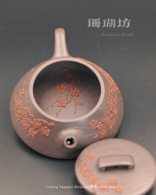 Handcrafted Yixing teapot with plum blossom carving on body